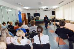 Wychowankowie bursy, przedstawiciel Komendy Miejskiej Policji w Ostrołęce podczas uczestniczenia w pogadance profilaktycznej. Miejsce świetlica bursy. 