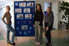 Grupa młodzieży pozuje na tle wystawy przygotowanej z okazji Światowego Dnia Wody.