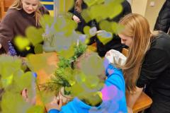 Młodzież podczas warsztatów plastycznych wykonuje stroiki bożonarodzeniowe