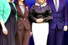 Mazowiecka Kurator Oświaty, Prezydent Miasta Ostrołęki oraz dwie wychowawczynie bursy stoją na scenie z przypiętymi Medalami Komisji Edukacji Narodowej. W tle znajduje się baner.