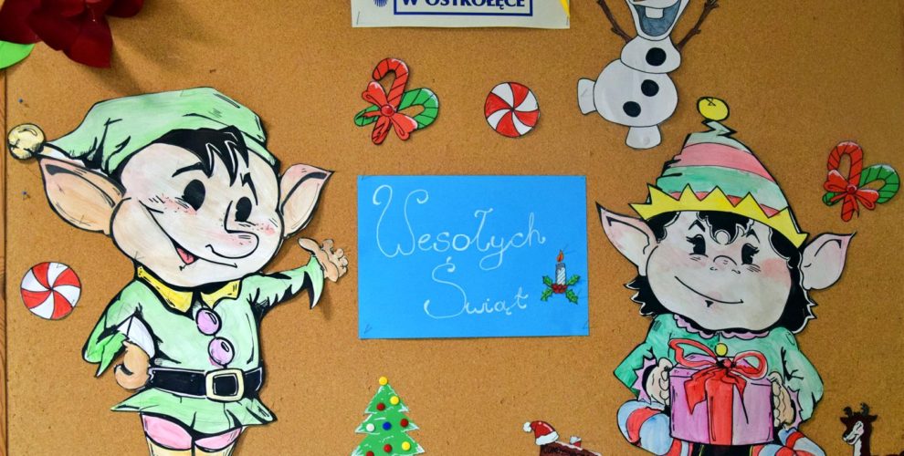 Zdjęcie przedstawia świąteczną gazetkę, na której znajdują się dwa kolorowe elfy wykonane z papieru. Pośrodku umieszczono biały napis „Wesołych Świąt” na niebieskim tle. Całość uzupełniają barwne dekoracje świąteczne wykonane przez młodzież, a w górnej części gazetki widnieje kolorowy logotyp Bursy